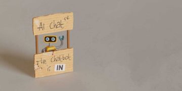 yellow toy robot manning ai chat stand 2024 10 18 06 40 39 utc